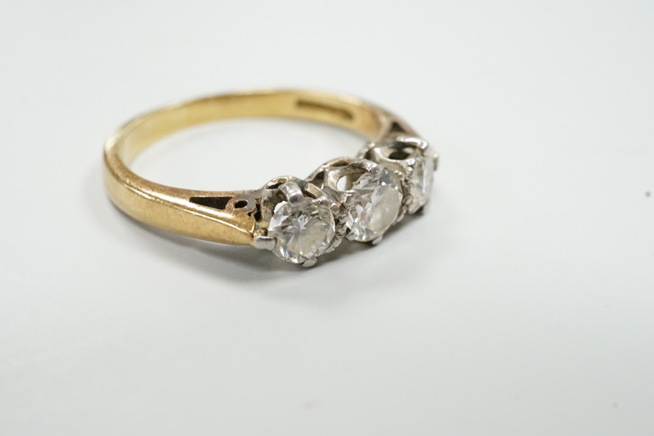 A modern 18ct gold and three stone diamond set ring, size K/L, gross weight 3.6 grams.
